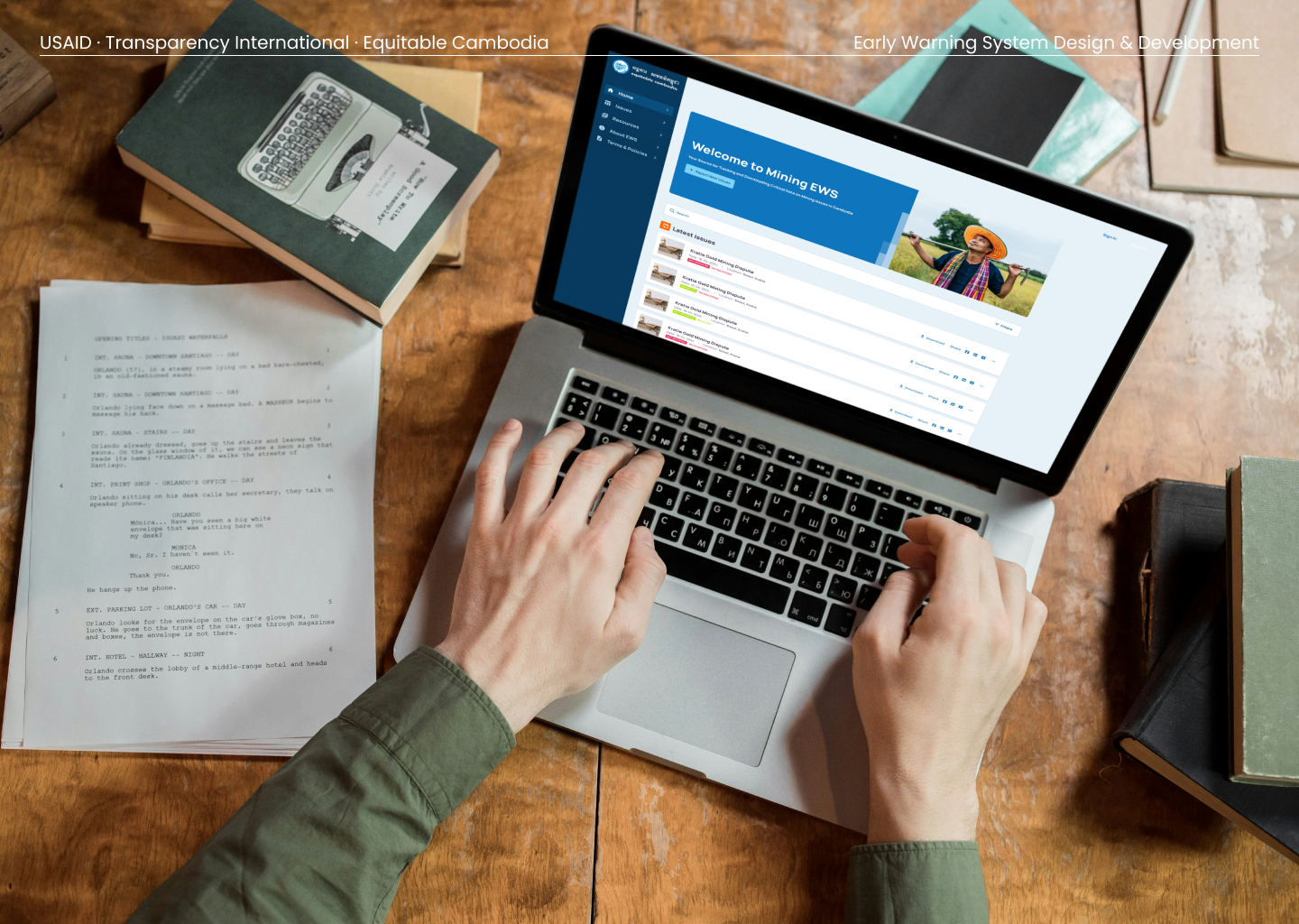 The Mining Early Warning System open on a laptop, showing the welcome screen and a list of the latest mining records